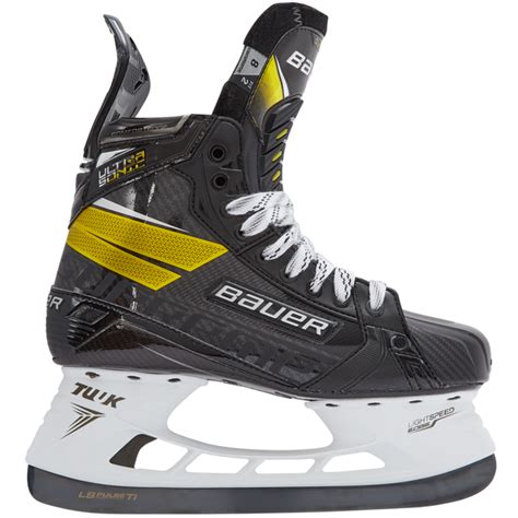An Ice Hockey Skate With Yellow And Black Accents