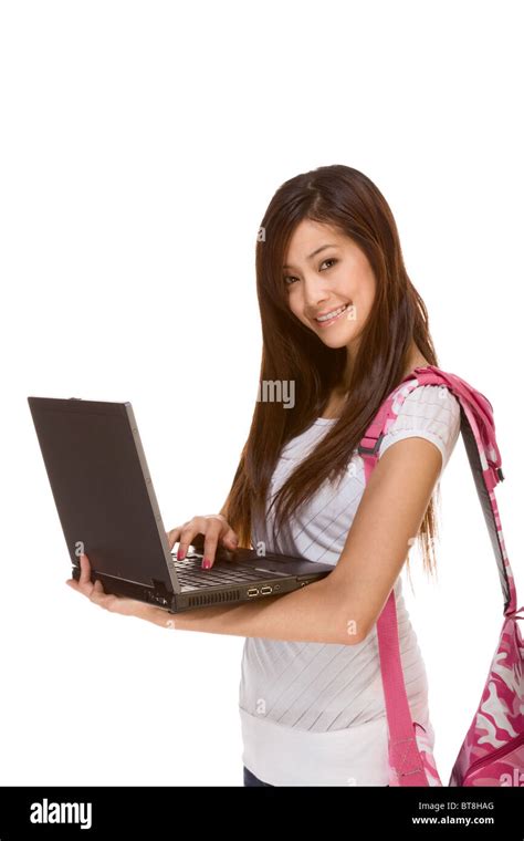 Friendly Asian High School Girl Student Standing In Jeans With Backpack