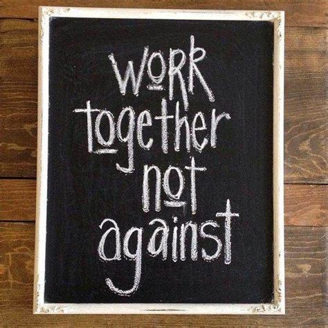 A Chalkboard With The Words Work Together Not Against