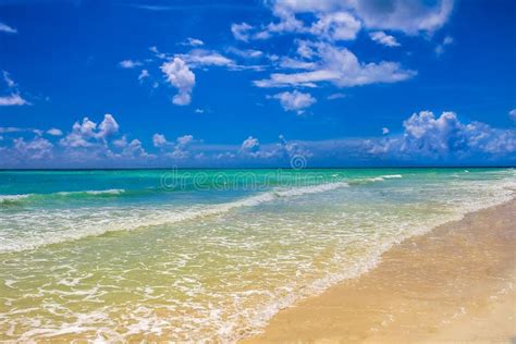Turquoise Water On A Tropical Sandy Beach With Beautiful Clouds Stock