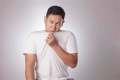 Premium Photo Portrait Of Funny Young Asian Man Smelling His Own Body