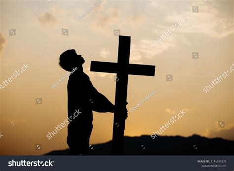 Silhouette Man Praying Before Cross Sunset Stock Photo 2141555223