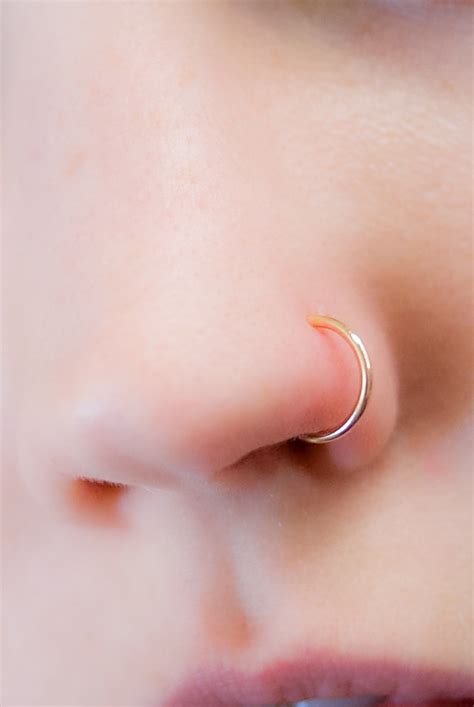 A Close Up Of A Woman S Nose With A Gold Nose Ring On It