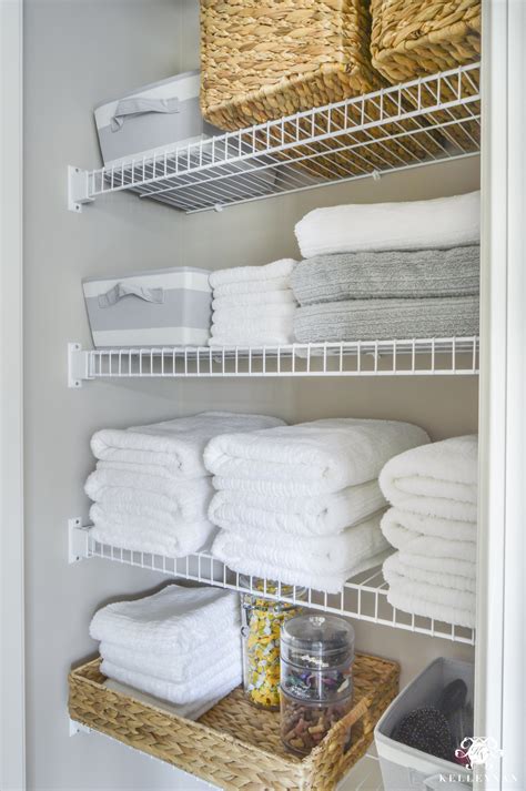 Km decor diy organizing open shelving in a bathroom boxes same type arranged facing different directions towels same color arranged. Organized Bathroom Linen Closet Anyone Can Have | Kelley Nan