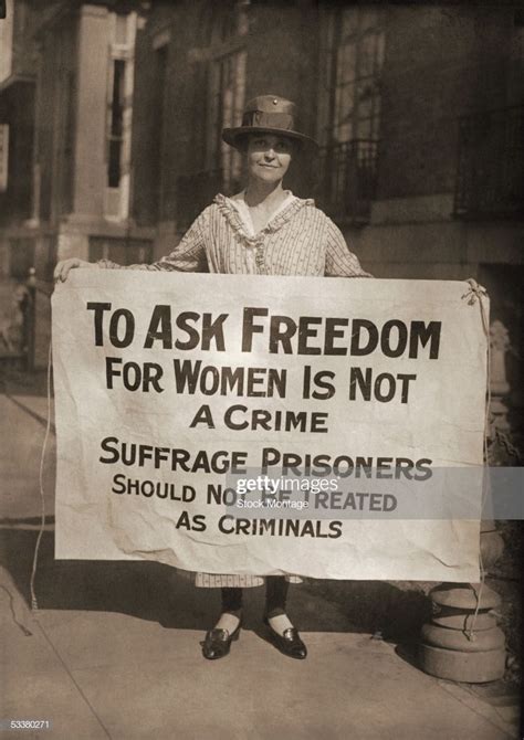 a woman pickets holding a sign reading to ask freedom for women is suffragette protest