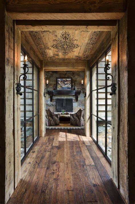 The Inside Of A House With Wood Floors And Large Glass Doors That Lead