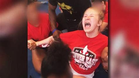 Cheerleader Screams As Teammates Force Her Into Split