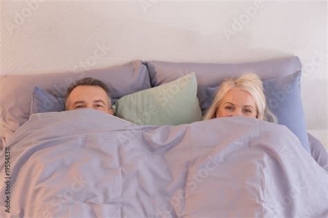 Senior Couple Hiding Under Blanket In Bed Together Stock Photo Adobe