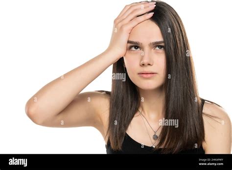 Portrait Of A Beautiful Teenage Girl Looking Up And Holding Her Head