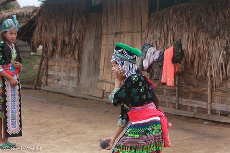 Hmong girl in traditional garb talking on a cell phone