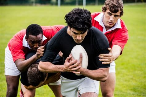 Premium Photo Rugby Players Tackling During Game