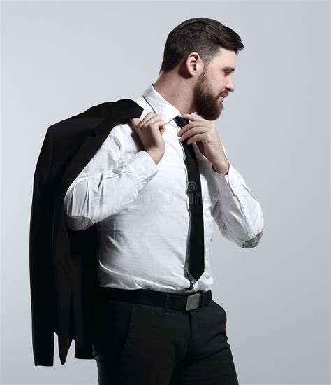 Businessman Holding His Jacket Over His Shoulder And Straightens His