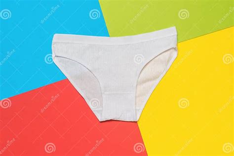 Beautiful White Panties On A Background Of Four Colors Minimal Concept Of Women`s Underwear