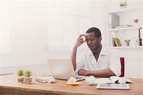 Tired African American Employee In Office Work With Laptop Stock Photo