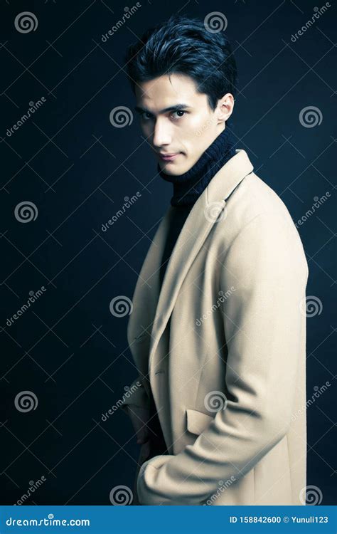 Cool Real Young Man In Coat On Black Background Posing Lifestyle
