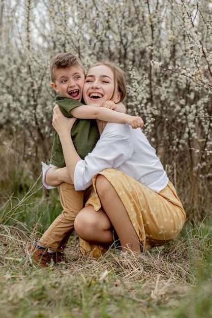 Premium Photo Happy Mother And Son Having Fun Together Mother Gently Hugs Her Son In The