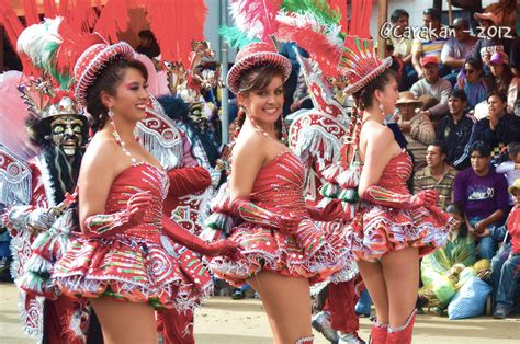 Three Gorgeous Morenada Dancers March Down The Street In Their Fancy