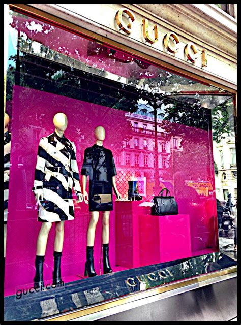 gucci storefront window display in hot pink black and white paris fashion retail interior