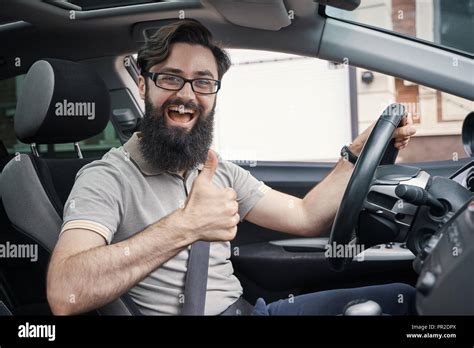Man Driver Happy Smiling Showing Thumbs Up Driving Sport Car With City