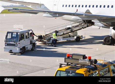 Ground Staff Handling An Aircraft Before Departure At The Airport