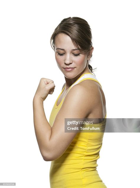 Healthy Young Woman Admiring Her Bicep Muscle High Res Stock Photo