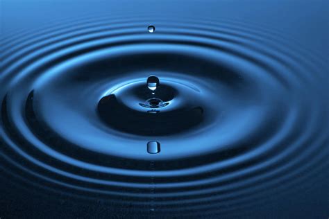 Water Drop Falling Into Water Making A Concentric Circles Photograph By