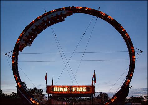 The Ring Of Fire Carnival Ride Lit Up At Sunset Photograph By