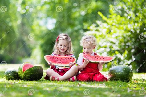 Kids Eating Watermelon In The Garden Stock Photo Image Of Friend