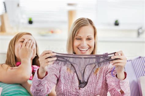 Laughing Women Holding Lingerie On The Sofa Stock Image Image Of