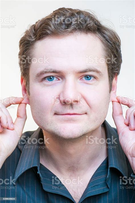 Portrait Of Man Points On His Ears Human Face Parts Stock Photo