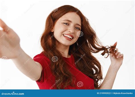 Beautiful Ginger Girl Playing With Her Red Hair And Smiling Taking