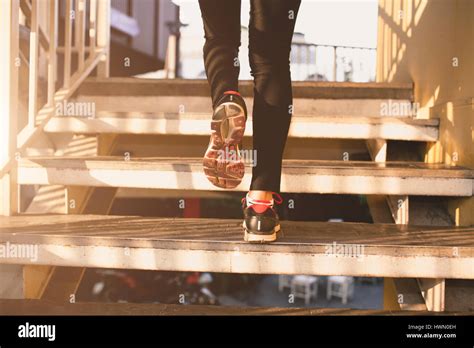 Close Up Of Feet With Sneakers Climbing Up The Stairs Stock Photo Alamy