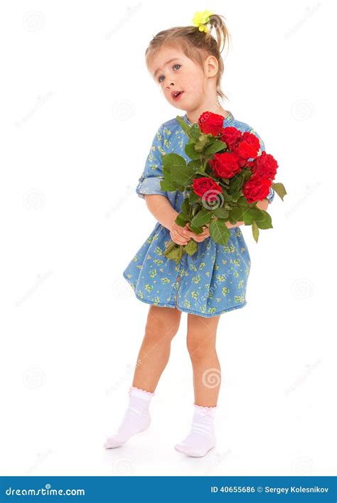 Charming Little Girl Holding A Bouquet Of Red Roses Stock Photo