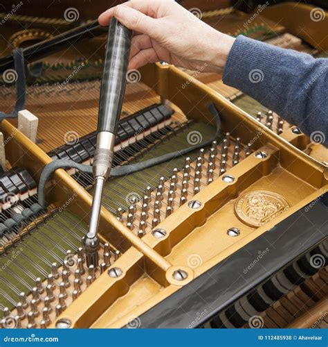 Hand and Tools of Tuner Working on Grand Piano Stock Photo - Image of