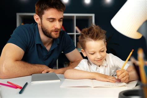 Premium Photo Dad And Son Doing School Homework Together