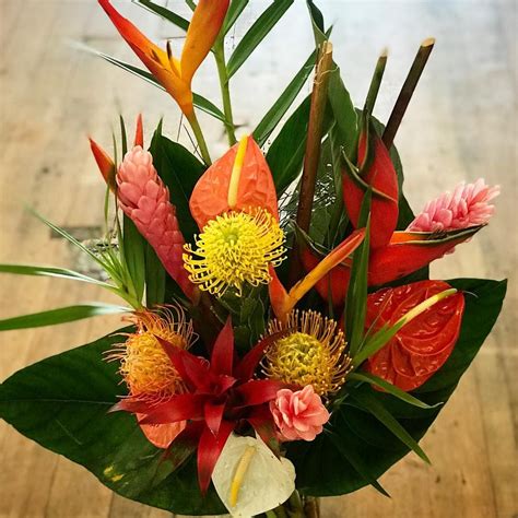 Tropical Floral Arrangement Featuring Bird Of Paradise Palm Leave Protea And Anthurium