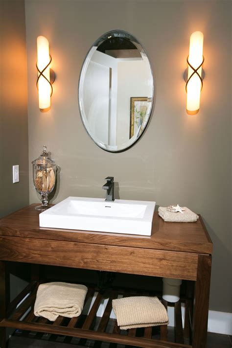 Powder Room Featuring Stained Wood Vanity With Raised Sink