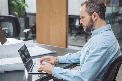Handsome Focused Architect Working With Laptop At Office Stock Photo