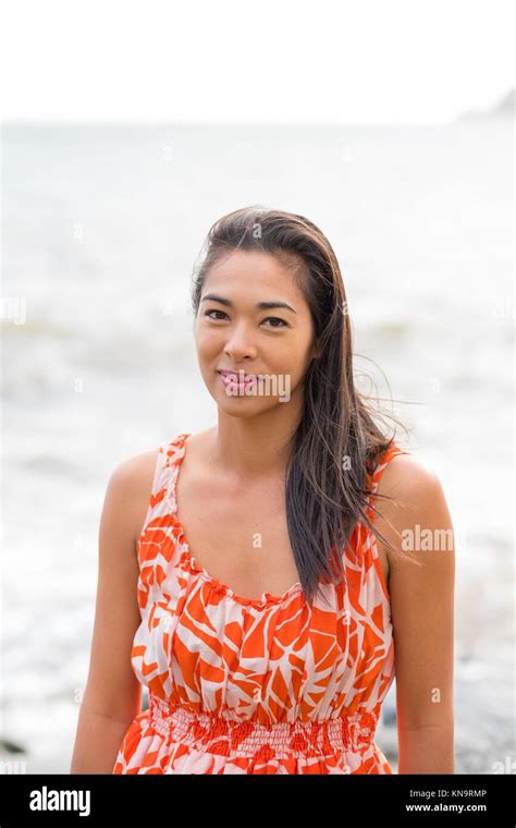 Lifestyle Portrait Of An Attractive Hawaiian Woman Wearing A Flower