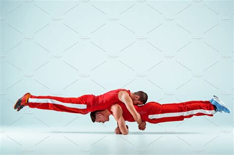 The Two Gymnastic Acrobatic Caucasian Men On Balance Pose Featuring