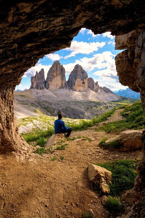 Hiker Admires The Three Peaks Of Lavaredo From The Caves Natural Park