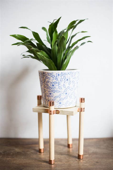 You could easily use these free plans and build one from different wood for indoors as well. Copper and Wood Plant Stand DIY - Live Free Creative Co