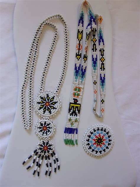 Beaded Necklaces And Bracelets Laid Out On A White Surface