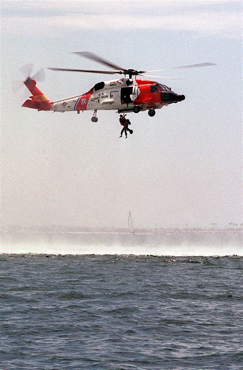 A Us Coast Guard Hh 60 Jayhawk Helicopter Lifting A 162nd Fighter Wing