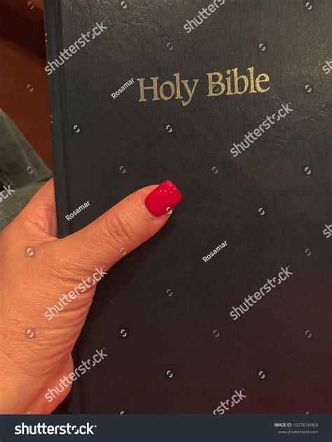Womans Hand Holding Holy Bible Stock Photo 1677616969 Shutterstock