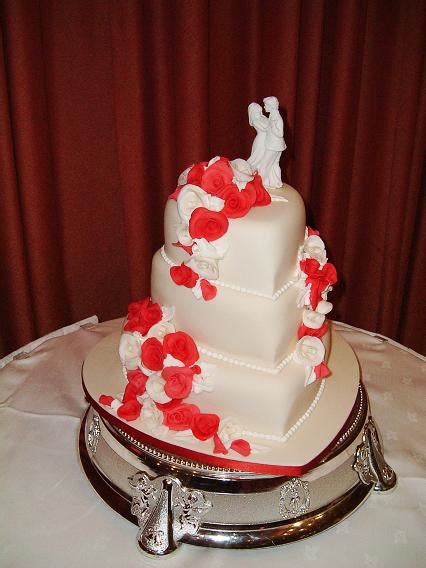 Three Tiered Cake Each Tier Is Heart Shaped Red And White Cascade