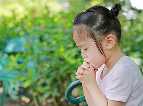 Little Child Girl Praying In The Garden Stock Photo Image Of Asia