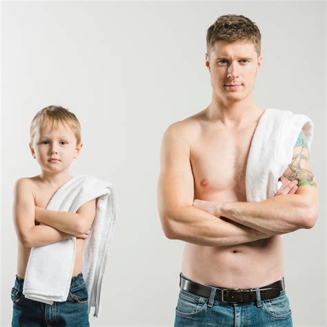 Free Photo Portrait Of Shirtless Father And Son With Their Arm Crossed Looking To Camera