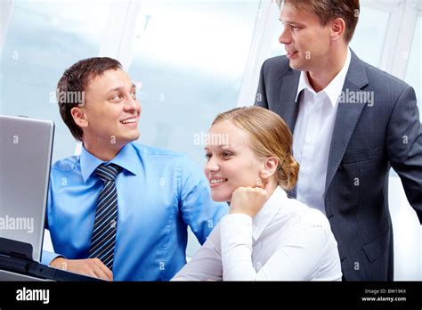 Portrait Of Two Businessmen Interacting While Pretty Employee Looking