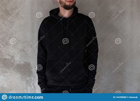Fashionable Young Man With A Beard In Black Stylish Clothes Is Standing